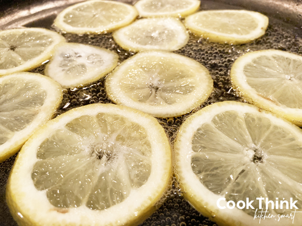 Simmering Lemon Chips: Professional Candied Lemon Slices. Photo by CookThink.