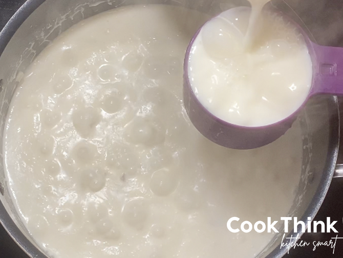adding milk to potato soup