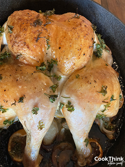 spatchcock chicken in a cast iron pan