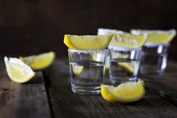 shot glasses with lemon garnishes