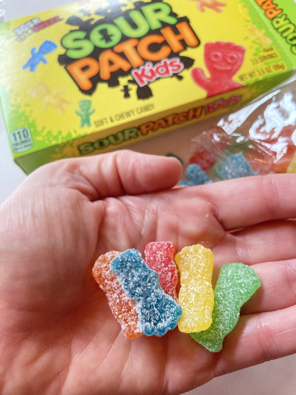 hand holding sour patch kids