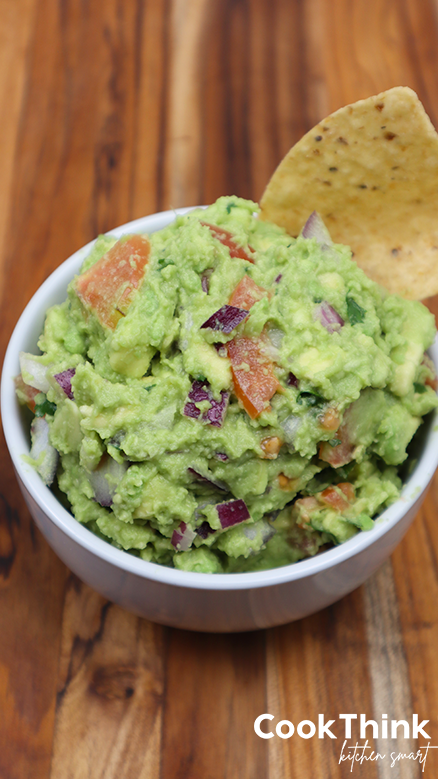 guacamole dip with a chip in bowl