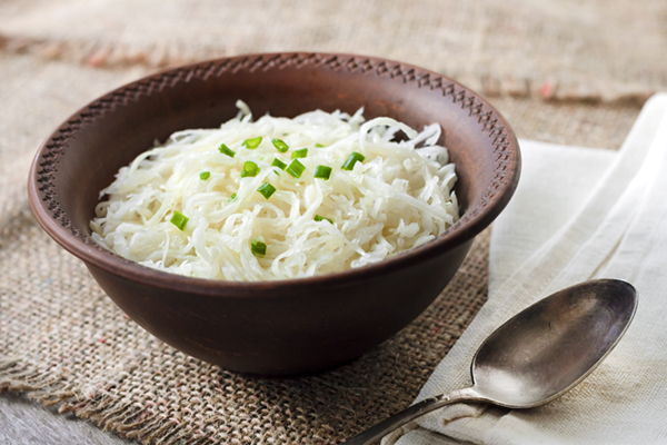 Sauerkraut with green onions in rustic bowl
