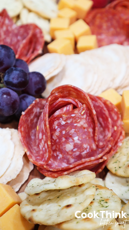 salami rose with crackers and grapes